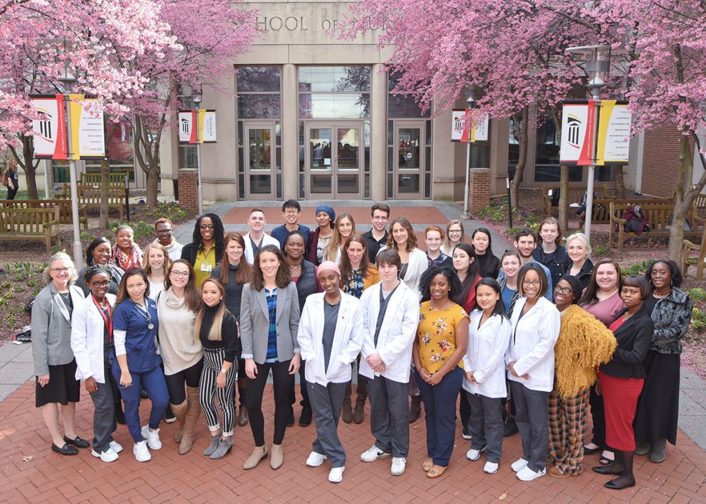 Dean Jane M. Kirschling (far left) poses for a photo with Conway Scholars outside the School of Nursing in Baltimore in March 2020.
