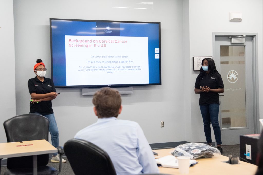 UMB CURE Scholars Markia Eubanks (left) and Ayishat Yussuf present their research at BD on human papillomavirus and cervical cancer. (Photo by Jena Frick)